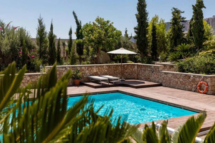 lounge area beside the pool with umbrella