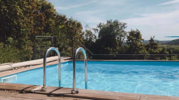 Swimming pool with railing and trees